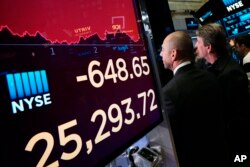 An electronic screen shows the drop in the Dow Industrials, May 13, 2019 at the New York Stock Exchange.