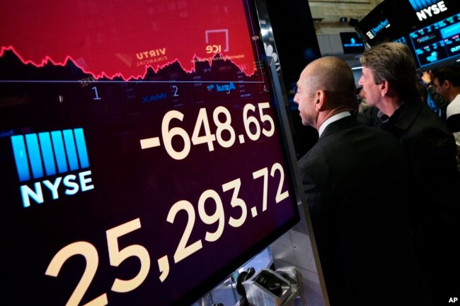 An electronic screen shows the drop in the Dow Industrials, May 13, 2019 at the New York Stock Exchange.