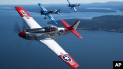 Air National Guard and the Heritage Flight Museum's P-51 Mustang flies over Seattle, Wash., July 30, 2015.