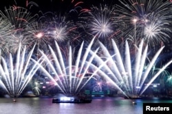 Fireworks explode over Victoria Harbour and Hong Kong Convention and Exhibition Centre during a pyrotechnic show to celebrate the New Year in Hong Kong, China January 1, 2019.