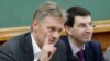 Russian President Vladimir Putin's spokesman Dmitry Peskov, left, speaks during a meeting in Moscow, Russia, Dec. 9, 2012. 