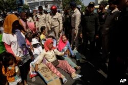 Farmers of Koh Kong province protesting land evictions are blocked by security during a protest rally as it moves near the Prime Minister's residence, in Phnom Penh, Cambodia, Tuesday, Feb. 14, 2017. (AP Photo/Heng Sinith)