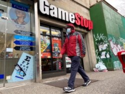 A man walks in front of a GameStop store in the Jackson Heights neighborhood of New York City, New York, U.S. January 27, 2021. REUTERS/Nick Zieminski