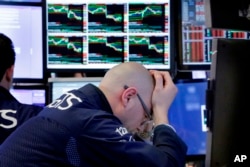 Specialist Mario Picone works at his post on the floor of the New York Stock Exchange, April 6, 2018. Stocks fell again as trade tensions grew between the U.S. and China.