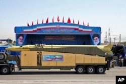 FILE - An Emad long-range ballistic surface-to-surface missile is displayed by the Revolutionary Guard during a military parade, in front of the shrine of late revolutionary founder Ayatollah Khomeini, just outside Tehran, Sept. 21, 2016.