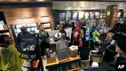 Demonstrators occupy the Starbucks that has become the center of protests Monday, April 16, 2018, in Philadelphia. (AP Photo/Jacqueline Larma)