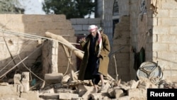 FILE - A man walks at the site of a Saudi-led air strike in the Houthi-held capital Sanaa, Yemen, Jan. 20, 2019. 