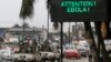 A U.N. convoy of soldiers passes a screen displaying a message on Ebola on a street in Abidjan, Ivory Coast, Aug. 14, 2014. 