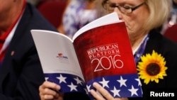 A delegate studies a copy of the Republican platform document that reflect the policies of the Republican Party that will be voted on at the RNC, at the Republican National Convention in Cleveland, Ohio, July 18, 2016. 