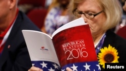 A delegate studies a copy of the Republican platform document that reflect the policies of the Republican Party that will be voted on at the Republican National Convention, in Cleveland, Ohio, July 18, 2016.