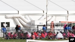 Immigrant children are shown outside a former Job Corps site that now houses them, June 18, 2018, in Homestead, Florida.