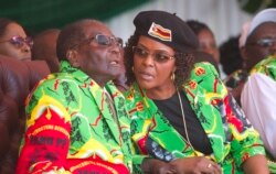 Zimbabwean President Robert Mugabe and his wife Grace follow proceedings during a youth rally in Marondera about 100 kilometers east of Harare, June, 2, 2017.