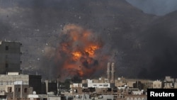 An airstrike hits a military site controlled by the Houthi group in Yemen's capital, Sana'a, May 12, 2015. 
