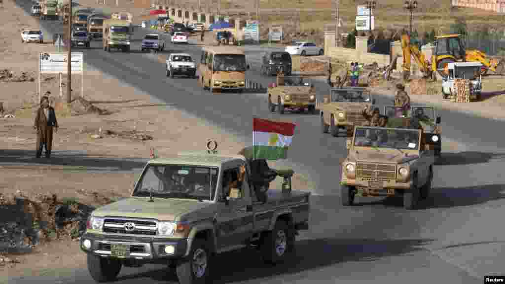A convoy of Kurdish peshmerga fighters drives through Irbil after leaving a base in northern Iraq, on their way to Kobani, Syria, Oct. 28, 2014. 