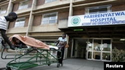 FILE: A patient is taken home on a stretcher by his relatives from Parirenyatwa hospital's accident and emergency ward in the capital Harare August 21, 2009. 