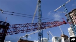 This Thursday, July 24, 2014 photo shows construction cranes at the Brickell City Centre project in downtown Miami. (AP Photo/Lynne Sladky)