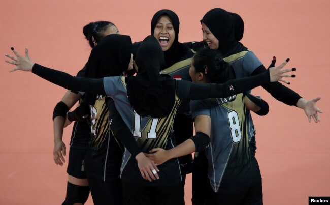 FILE - Indonesia players celebrate a point during the Southeast Asian Games match against Vietnam in Pasig, Philippines on Dec. 5, 2019.