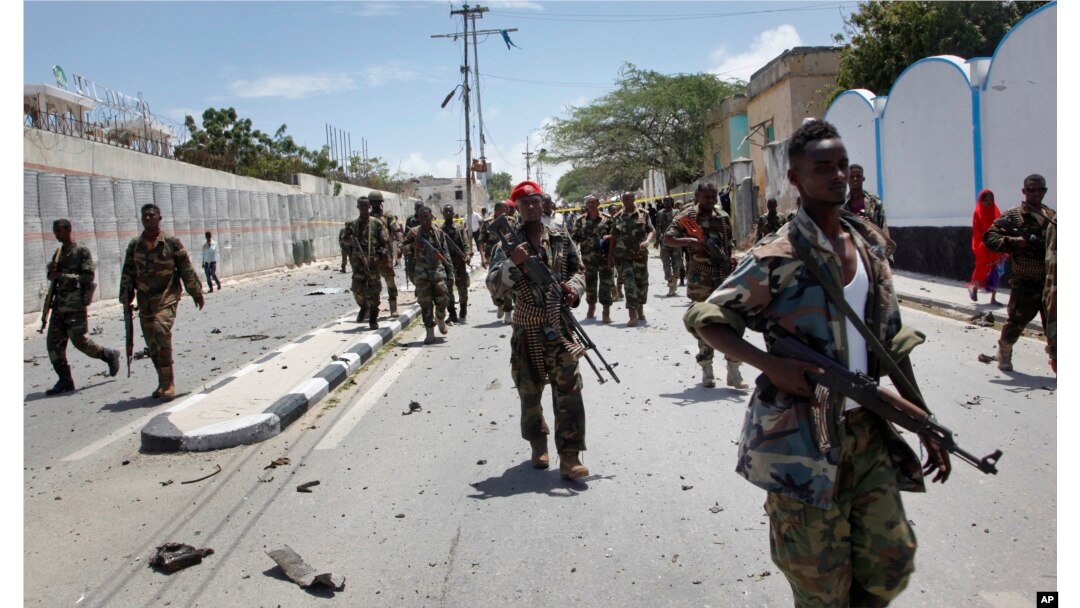 FILE - Somali government soldiers patrol after a blast near the presidential palace in the capital Mogadishu, Somalia, Aug. 30, 2016.