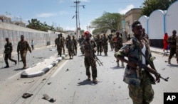 FILE - Somali government soldiers patrol after a blast near the presidential palace in the capital Mogadishu, Somalia, Aug. 30, 2016.