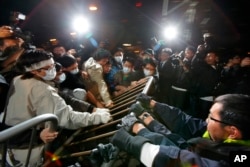 FILE - Protesters scuffle with police officers during a protest outside Hong Kong's Legislative Council, Jan. 16, 2010, after a controversial $8.6 billion plan to link Hong Kong to a national high-speed rail network won approval from local lawmakers.