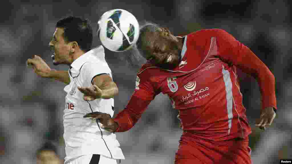 Lekhwaiya's Dame Traore (R) fights for the ball with Al-Sadd's Younes Mahmoud during their final Crown Prince Cup soccer match in Doha May 4, 2013.