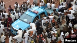 Applicants scale a fence during a job recruitment drive in Abuja March 15, 2014.