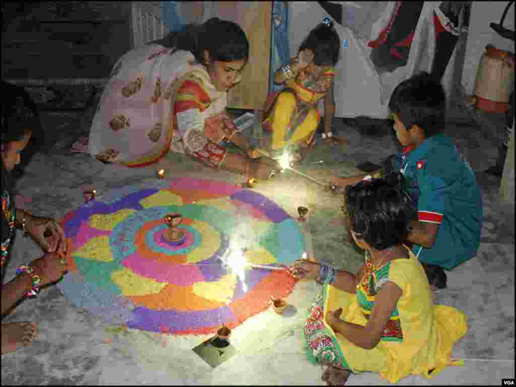 دیوالی کے موقع پر خواتین گھر کے آنگن کو رنگوں اور چراغوں سے سجاتی ہیں