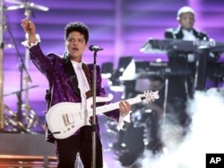 Bruno Mars performs "Let's Go Crazy" during a tribute to Prince at the 59th annual Grammy Awards, Feb. 12, 2017, in Los Angeles.