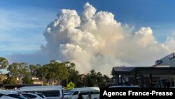 FILE - This May 2, 2021, photo shows smoke filling the sky as Sydney is enveloped in a thick bank of hazardous bushfire smoke, forcing authorities in Australia's largest city to scale back controlled forest burning nearby. 