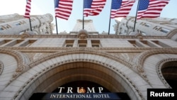 FILE - Flags fly above the entrance to the new Trump International Hotel on its opening day in Washington, DC, U.S. on Sept. 12, 2016. 