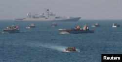 FILE - The Indian military's Landing Craft Mechanised (LCM) and infantry combat vehicles take part in a joint amphibious warfare exercise