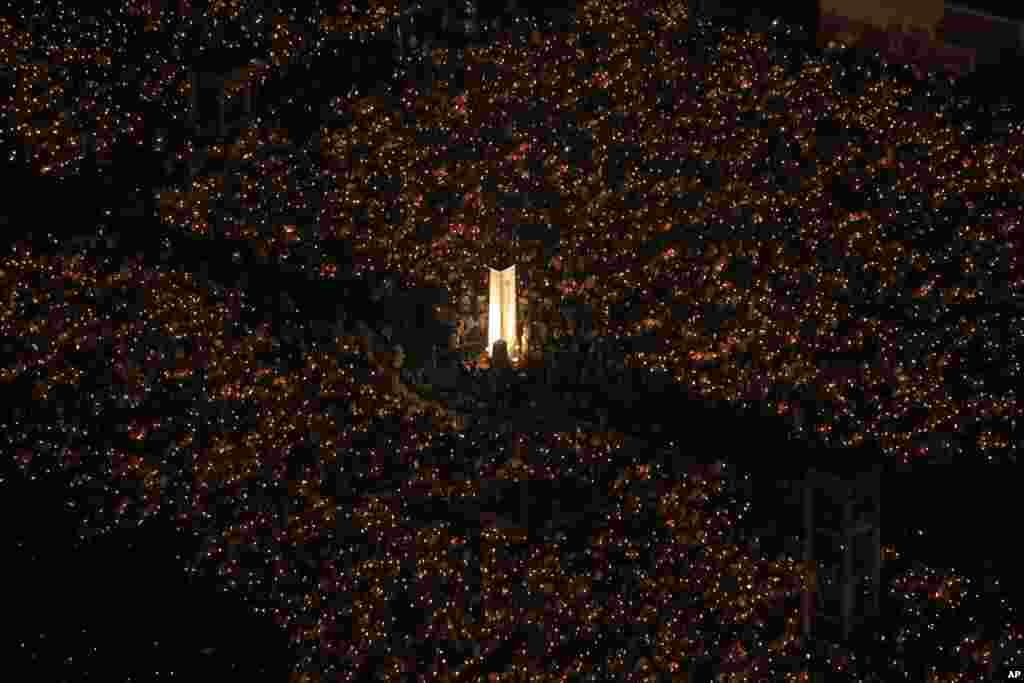 Tens of thousands of people attend a candlelight vigil at Victoria Park in Hong Kong to mark the 25th anniversary of the crackdown in China&#39;s Tiananmen Square.
