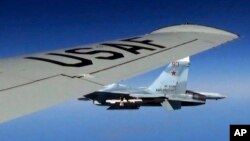 A U.S. RC-135U flying in international airspace over the Baltic Sea, is intercepted by a Russian SU-27 Flanker on June 19, 2017. The Russian military said it scrambled a fighter jet to intercept and escort a U.S. strategic bomber flying over the Baltic.