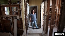 Nicole Chati is in what is left of her home after Superstorm Sandy in the Staten Island borough of New York, Sept. 20, 2013.