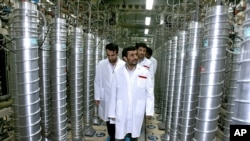 Former Iranian President Mahmoud Ahmadinejad, center, visits the Natanz Uranium Enrichment Facility some 200 miles (322 kilometers) south of the capital Tehran, Iran, April 8, 2008.