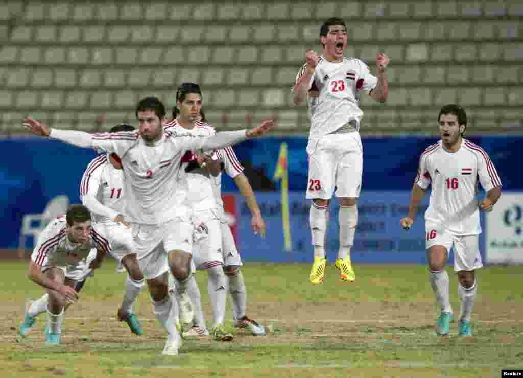 Syria's players celebrate after winning their West Asian Football Federation (WAFF) Championship semi-final soccer match against Bahrain in Kuwait City December 18.