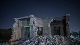 A building stands partially demolished after bulldozers cleared the way for construction of a multilane freeway through the Northern Cemetery, part of the historic City of the Dead, a UNESCO World Heritage Site in Cairo, Egypt, Sunday, July 26, 2020. (AP Photo)