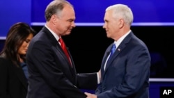 Republican vice-presidential nominee Gov. Mike Pence, right, and Democratic vice-presidential nominee Sen. Tim Kaine shake hands during the vice-presidential debate at Longwood University in Farmville, Va.
