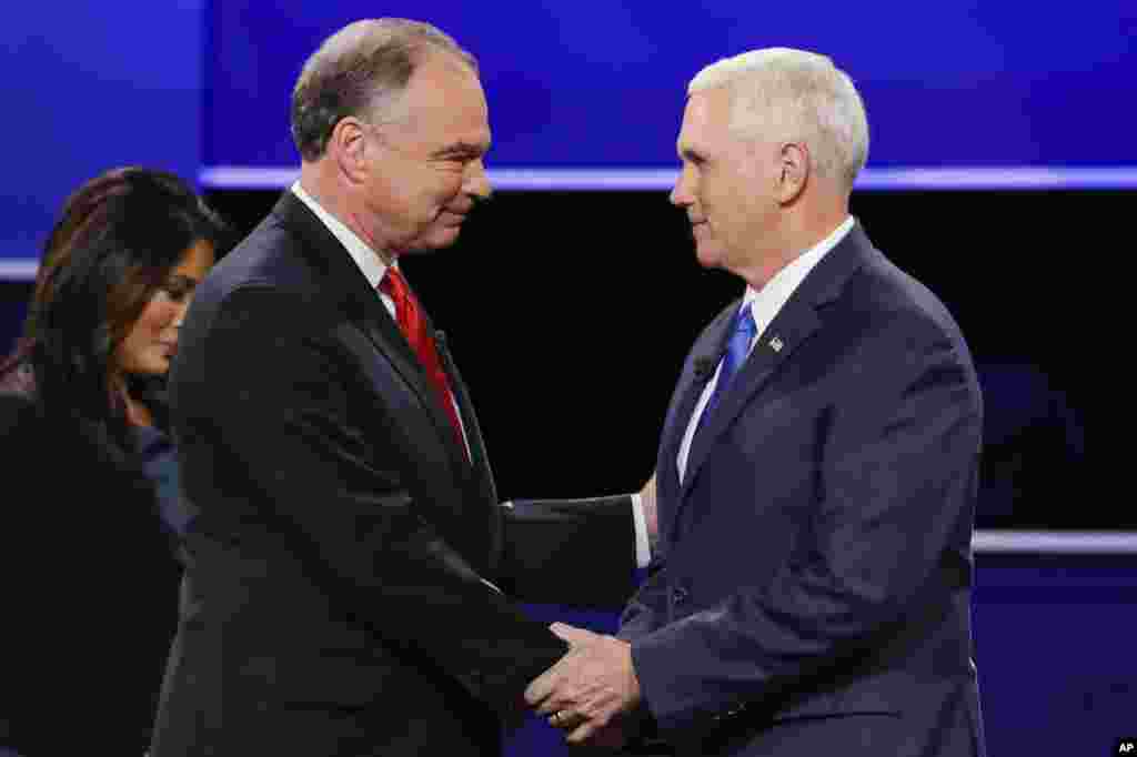 Republican vice-presidential nominee Gov. Mike Pence, right, and Democratic vice-presidential nominee Sen. Tim Kaine shake hands during the vice-presidential debate at Longwood University in Farmville, Va.
