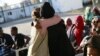 Relieved and happy to be released from detention, a refugee hugs UNHCR staff as they meet at the Gathering and Departure Facility in Tripoli, Libya. (UNHCR/Mohamed Alalem)