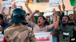Iraqi protesters chant slogans demanding services and jobs during a demonstration in Tahrir Square, Baghdad, July 14, 2018.