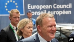 FILE - Danish Prime Minister Lars Lokke Rasmussen, right, arrives for an EU summit in Brussels, June 28, 2016.