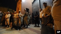 Egyptian security forces stand guard at a Coptic Christian church after gunmen opened fire, killing four people and wounding several others, in the Waraa neighborhood of Cairo late Sunday, Oct. 20, 2013.
