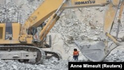 FILE: Rosalie Guiro Kulga, 30, excavator-conductor, poses for a photograph beside her engine at the gold mine site in Hounde, Burkina Faso February 11, 2020