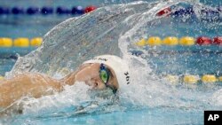 FILE - China's Sun Yang swims in his men's 200m freestyle heat at the 17th Asian Games in Incheon, South Korea, Sept. 21, 2014. Olympic and world champion swimmer Sun served a three-month ban after testing positive for a banned stimulant.