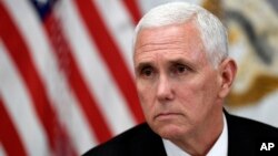 Vice President Mike Pence listens in the Vice President's Ceremonial Office on the White House complex in Washington, during a meeting with family members of the six Citgo executives currently detained in Venezuela, April 2, 2019.