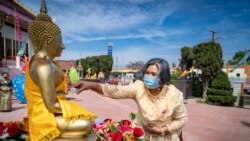 A woman pours water on the Buddha statues during traditional Thai New Year celebrations or the Songkran festival at Wat Thai Los Angeles Temple, Los Angeles, CA, April 11, 2021.