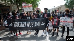 Demonstrators march during a Juneteenth march and rally in Washington, DC, on June 19, 2020.