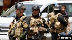 Les membres des Forces d'opérations spéciales irakiens montent la garde lors d'un déploiement de sécurité intensive dans le quartier Amiriya à Bagdad , le 18 Juin , 2014.