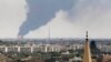 Smoke rises over an oil depot in Libya's capital, Tripoli, as rival militias plague the nation's civilian populations.